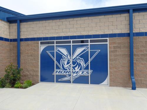 Printed and installed window perforation on athletic building.